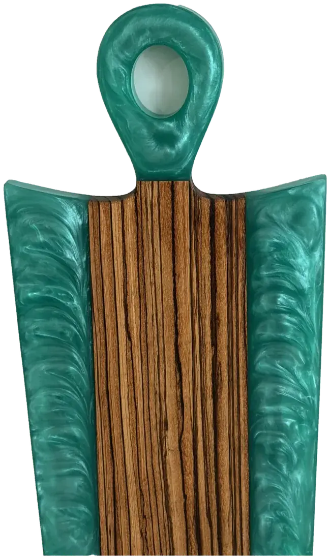 Tigerwood paddle-style charcuterie board with teal resin handle and edges